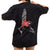 Black oversized t-shirt with a red and white graphic of a bird on the back, worn by a person.
